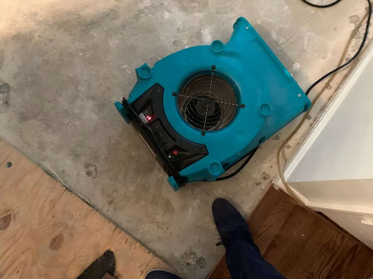 Air mover drying subfloor during Commercial Water Damage Restoration in Coachella